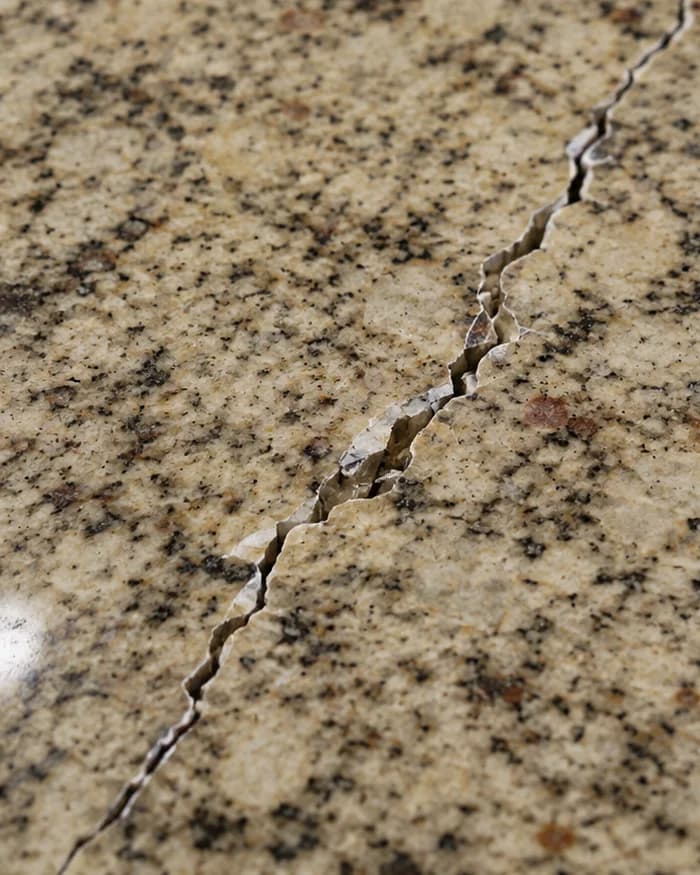 Chipped edge on a granite kitchen island before repair in Vaughan
